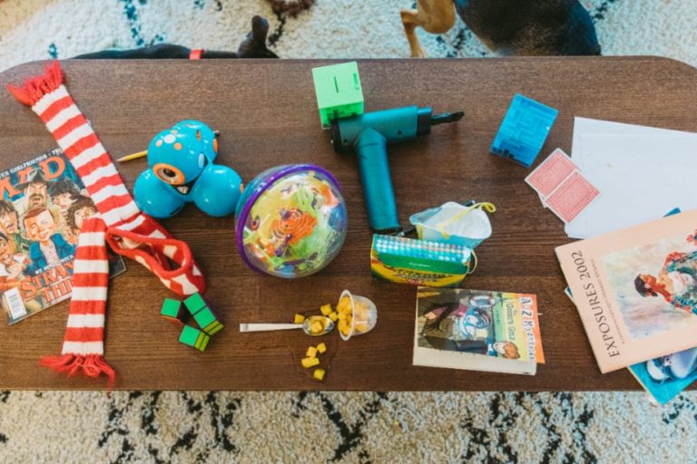 A messy coffee table in a home with children.